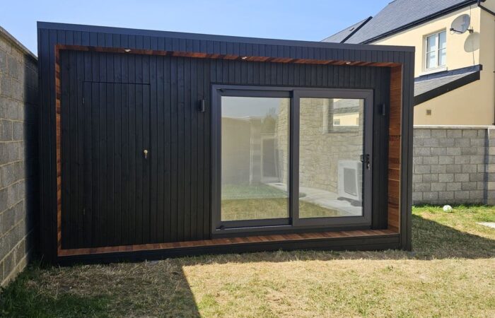 Black garden room in Ardclough Co. Kildare with cedar corner accent and anthracite sliding doors